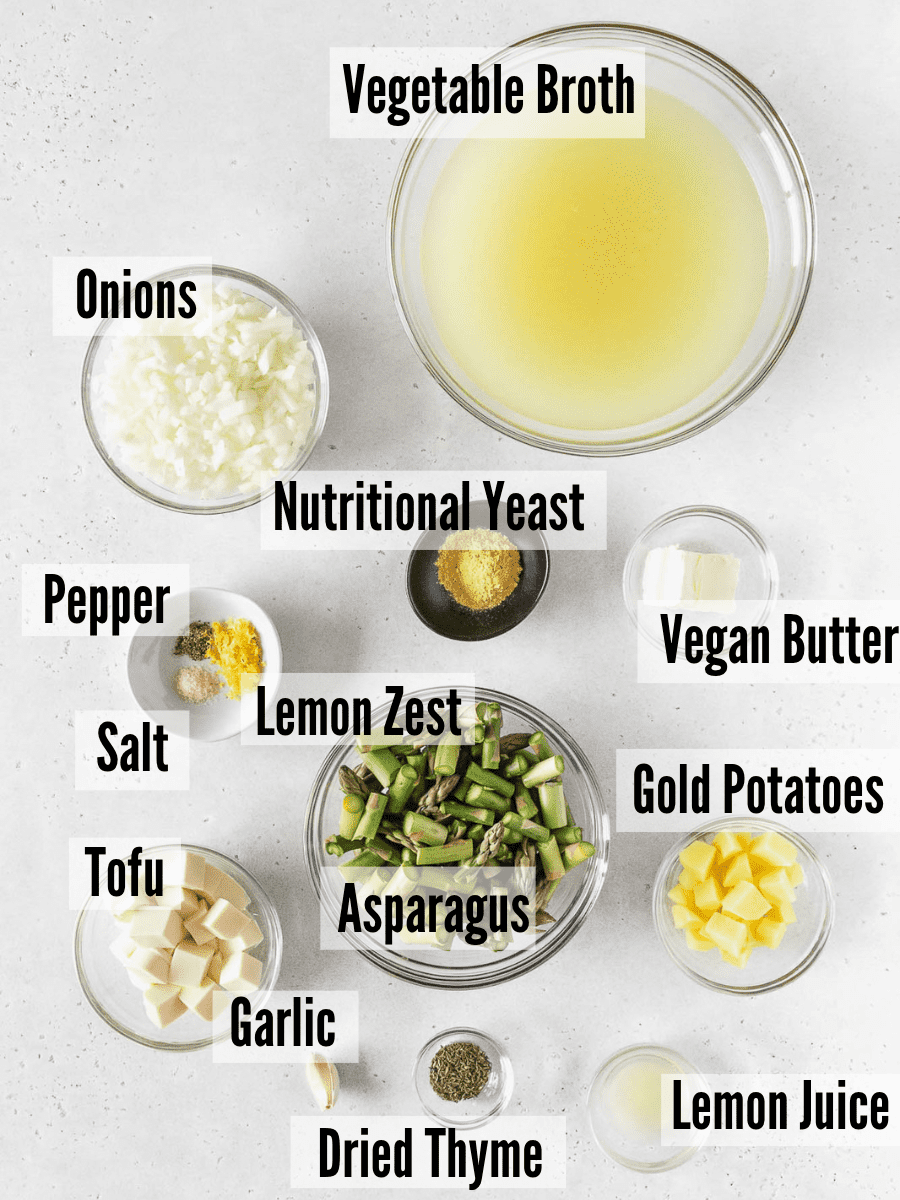 All of the ingredients for asparagus soup without cream on a white background.
