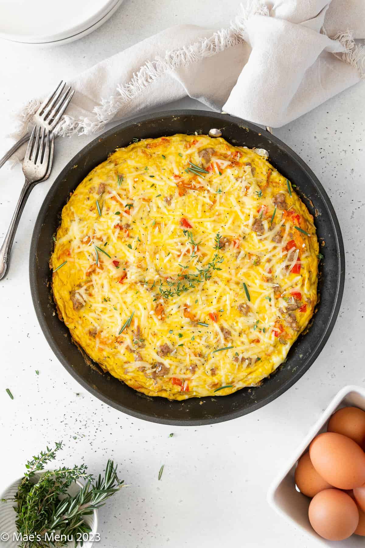 An overhead shot of a large skillet of sweet potato and sausage frittata.