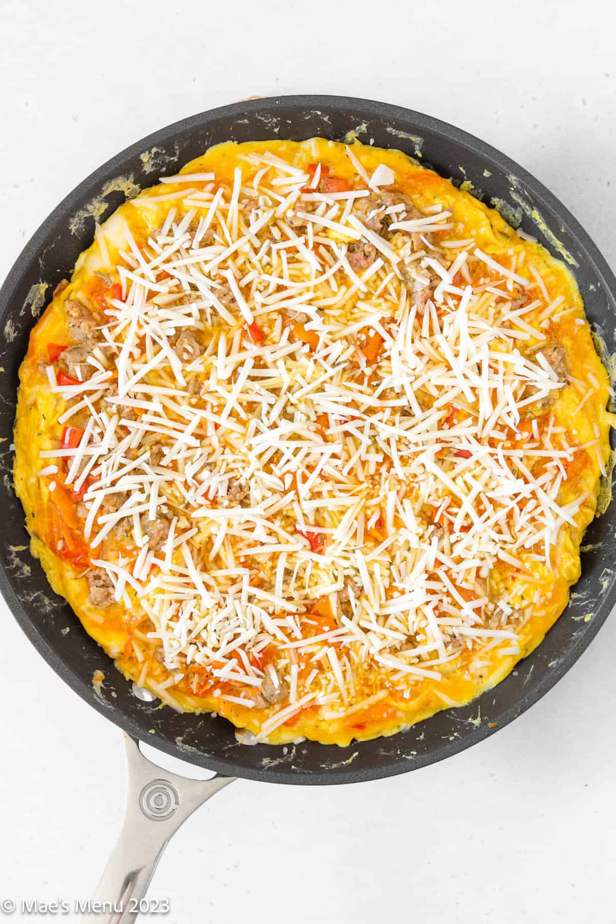 Sprinkling extra cheese on top of the sweet potato skillet in a large non-stick skillet.