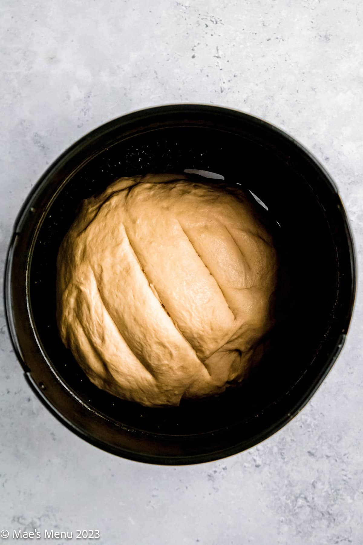 A loaf of air fryer bread in the air fryer basket before baking.