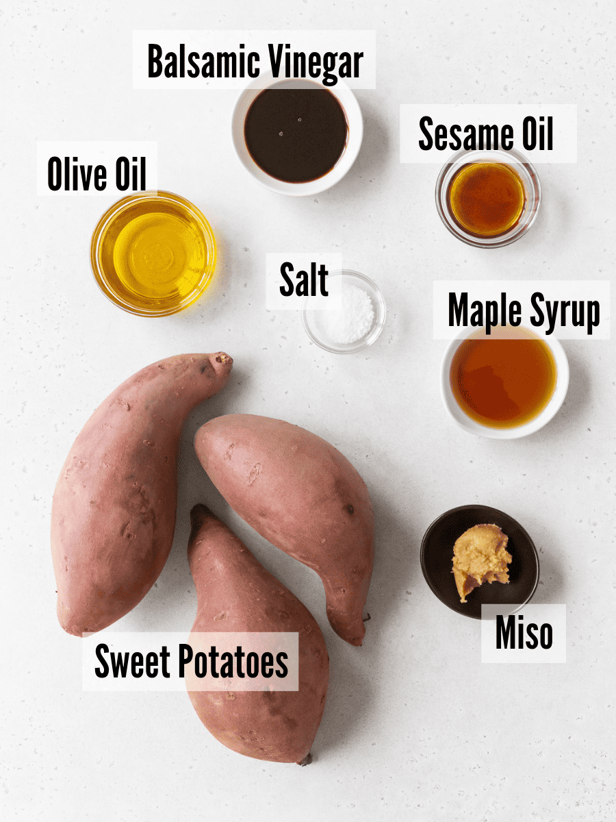 All of the ingredients for crispy roasted sweet potatoes on a white background.