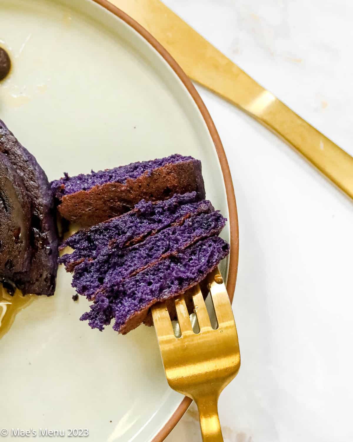 An up-close overhead shot of a forkful of ube pancakes.