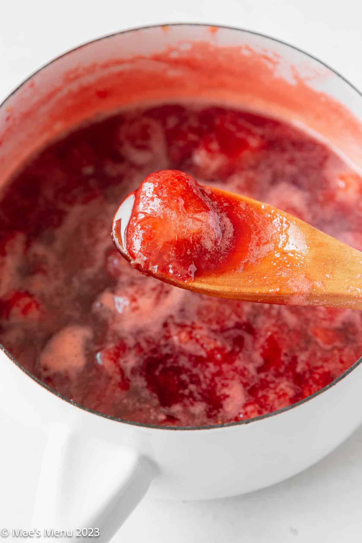 A saucepan of simmered strawberries and lemon juice.