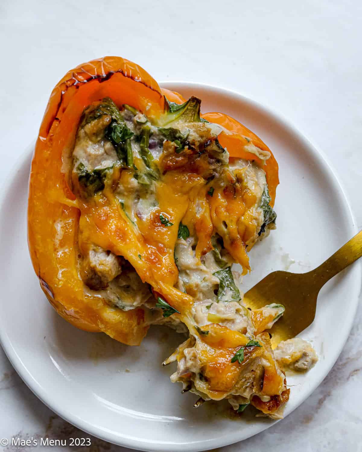 A tuna stuffed pepper with a bit taken out of it. 