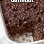A pinterest pin for brownie baked oatmeal with an angled shot of a large white pan of it with a scoop taken out of it.