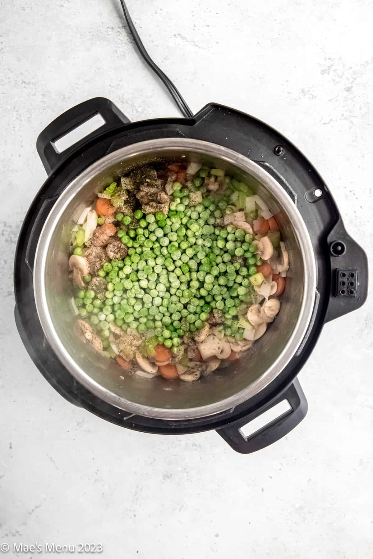 Vegetables and green peas cooking in the Instant Pot.