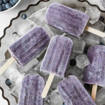 An overhead shot of a large tray of protein popsicles on ice.
