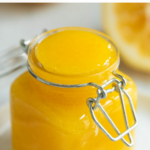 A pinterest pin for meyer lemon curd with a closeup shot of the curd in a small jar.