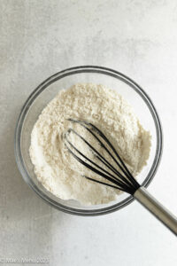 A flour mixture whisked up in a mixing bowl.