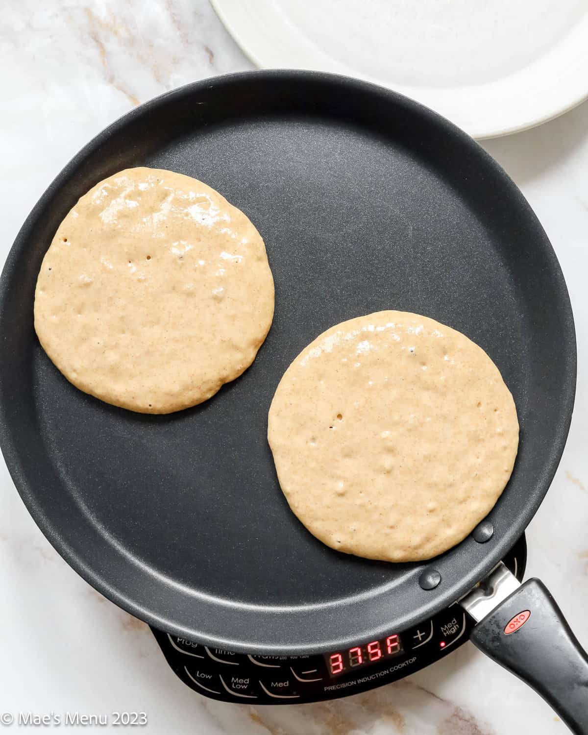 Cooking the pancakes on a griddle.