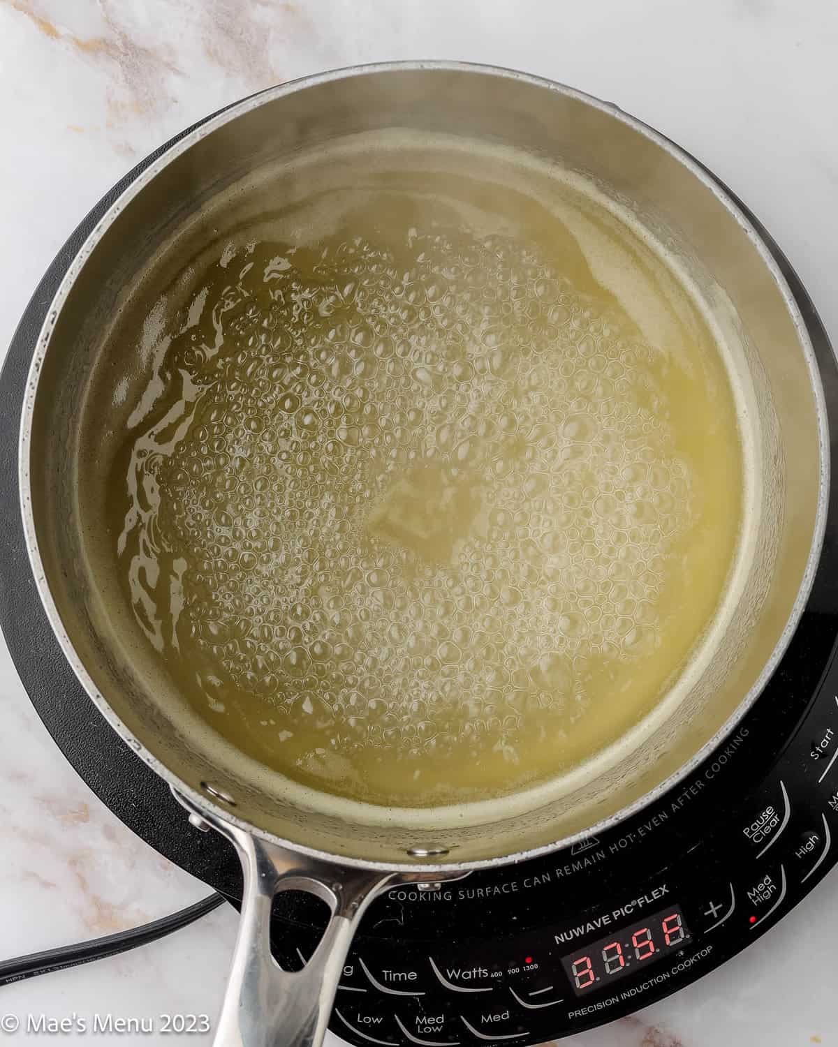 Pineapple syrup simmering in a pan.