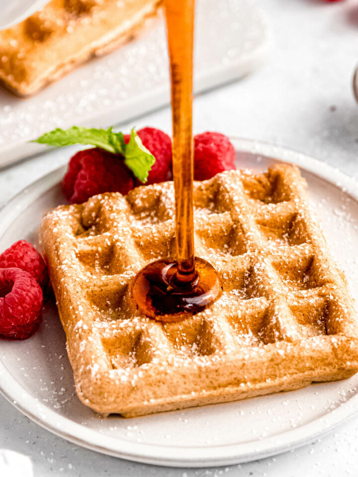 Closeup shot of pouring the maple syrup over the dairy-free waffle.