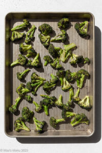 Overhead shot of a sheet pan of roasted broccoli.