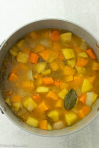 A pot of simmered butternut squash and vegetables.
