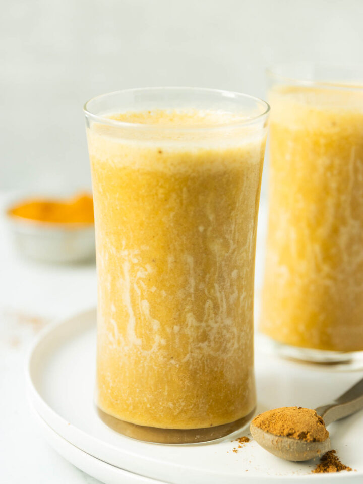 A side shot of a frosty glass of pumpkin protein shakes.