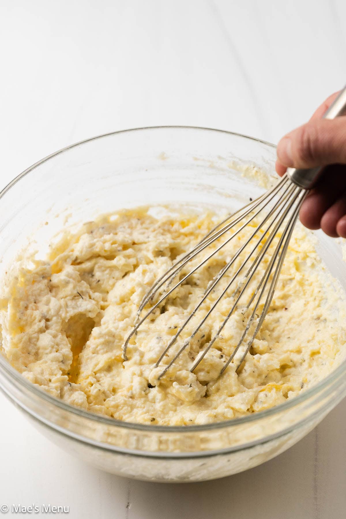 A close-up shot of whisking the cheesy ricotta filling.