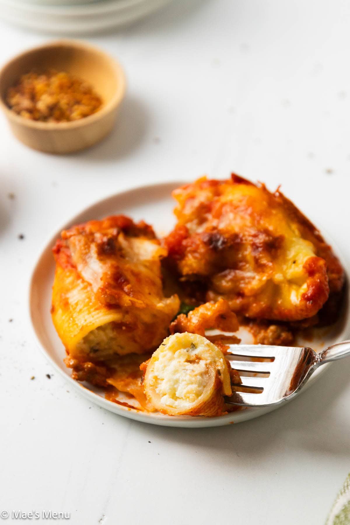 A close-up shot of the stuffed shells with one cut open.