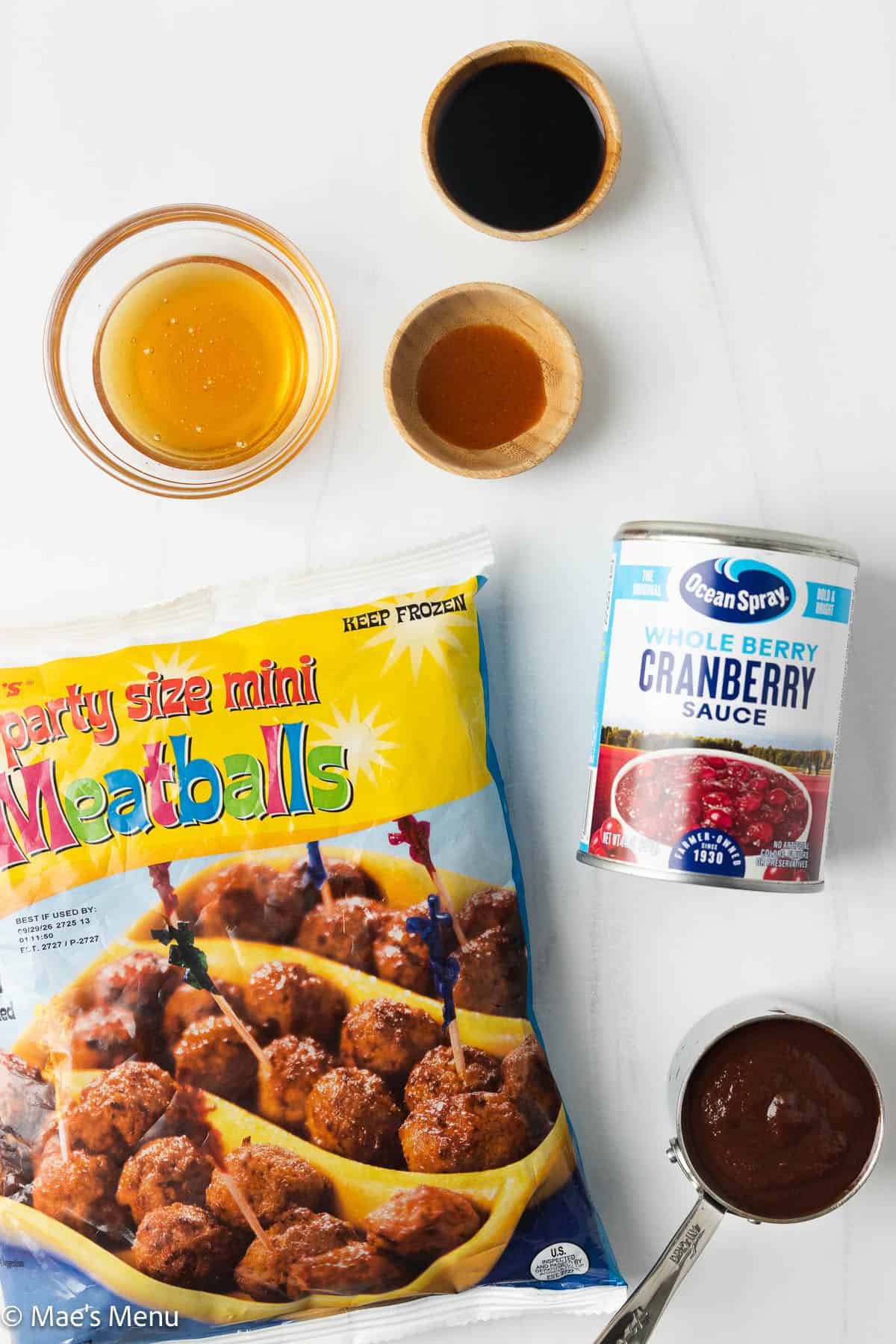 All the ingredients needed to make cranberry meatballs ont he coutner