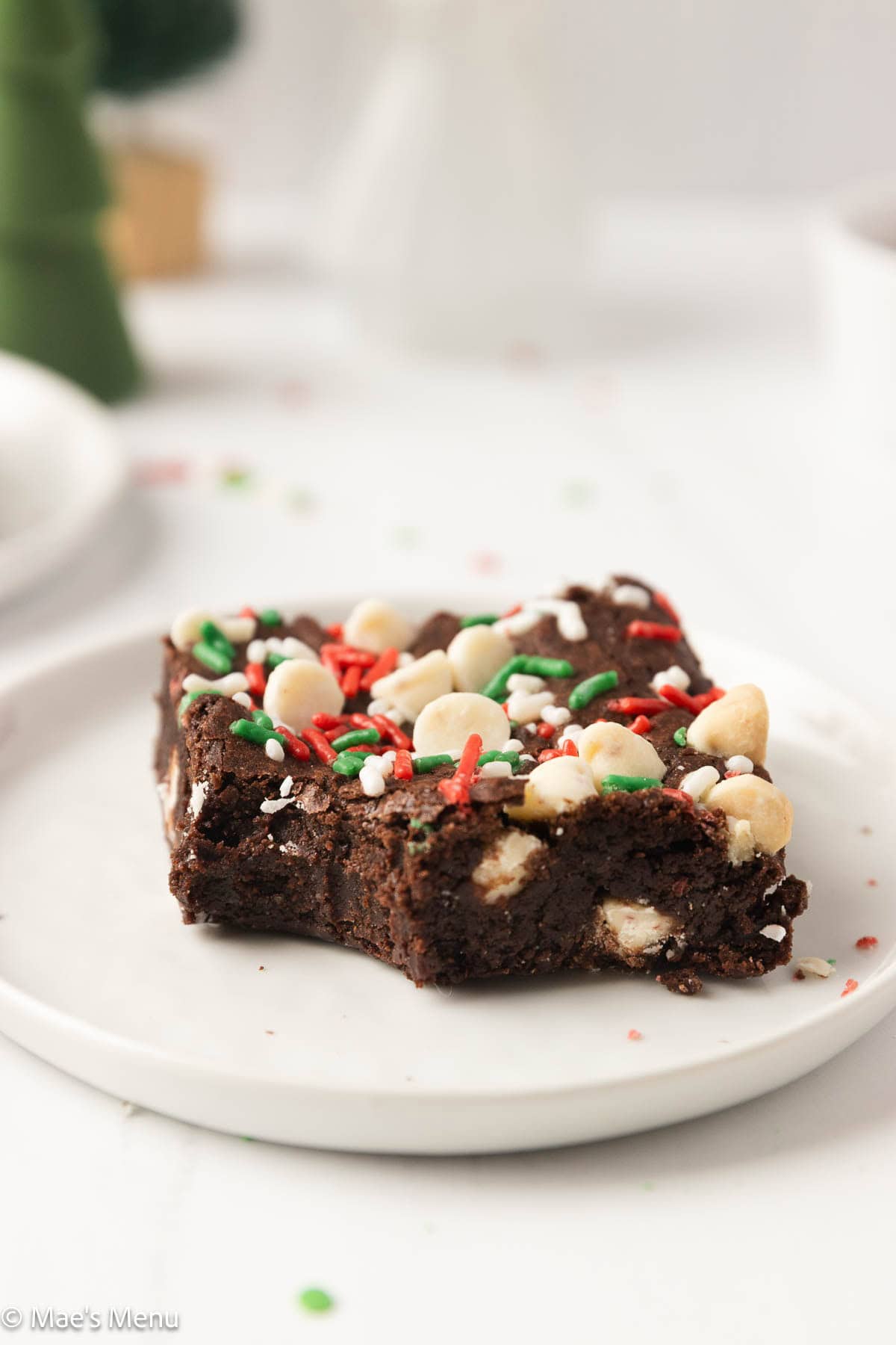 A close-up shot of a peppermint christmas brownie with a bite taken out of it. 