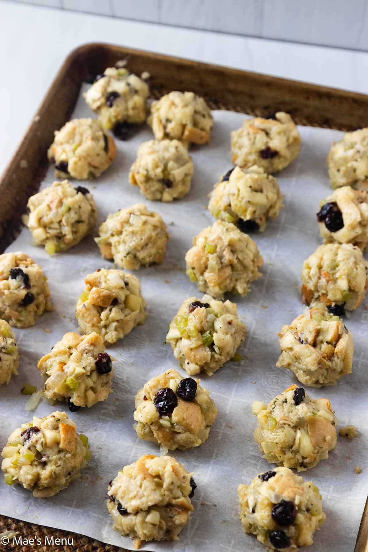 A baking sheet of stuffing balls before going into the oven.