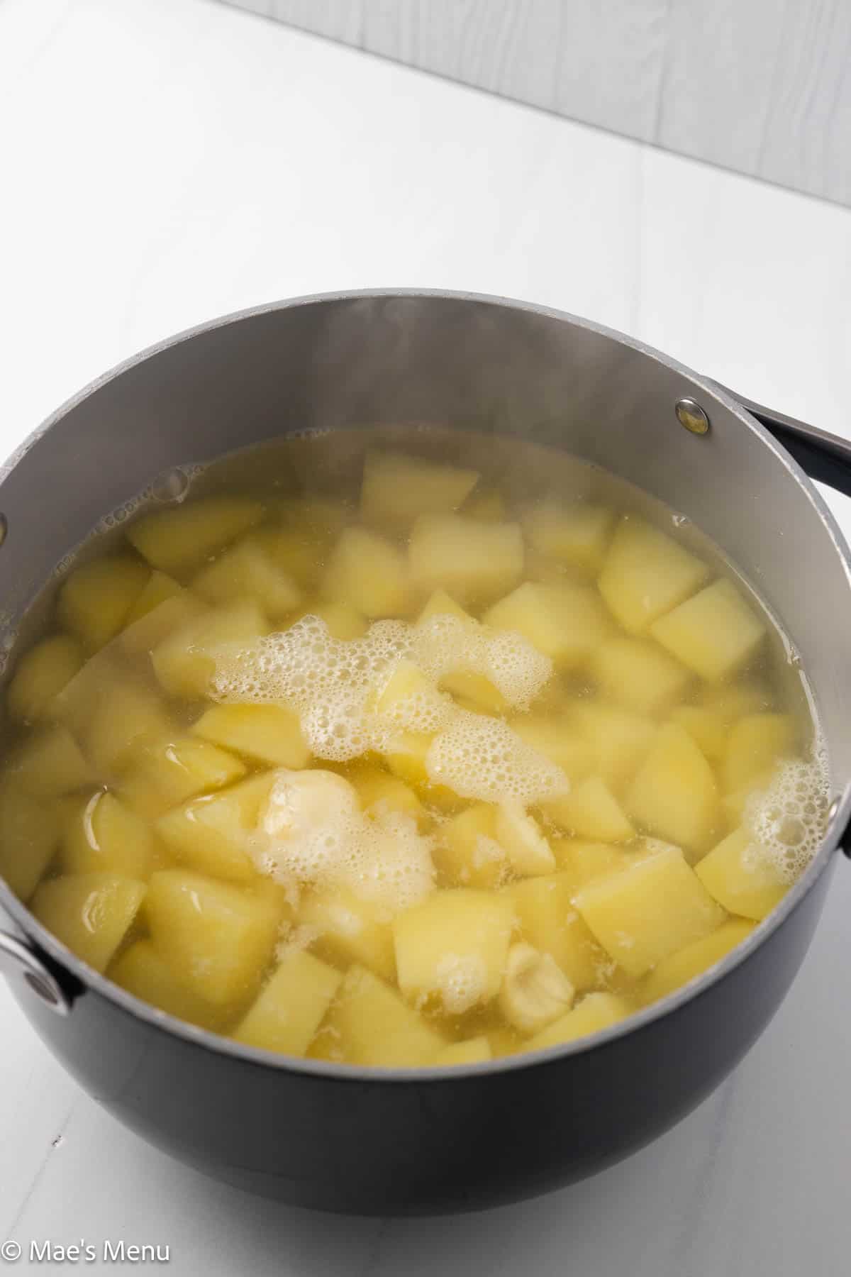A pot of boiled potatoes before draining.
