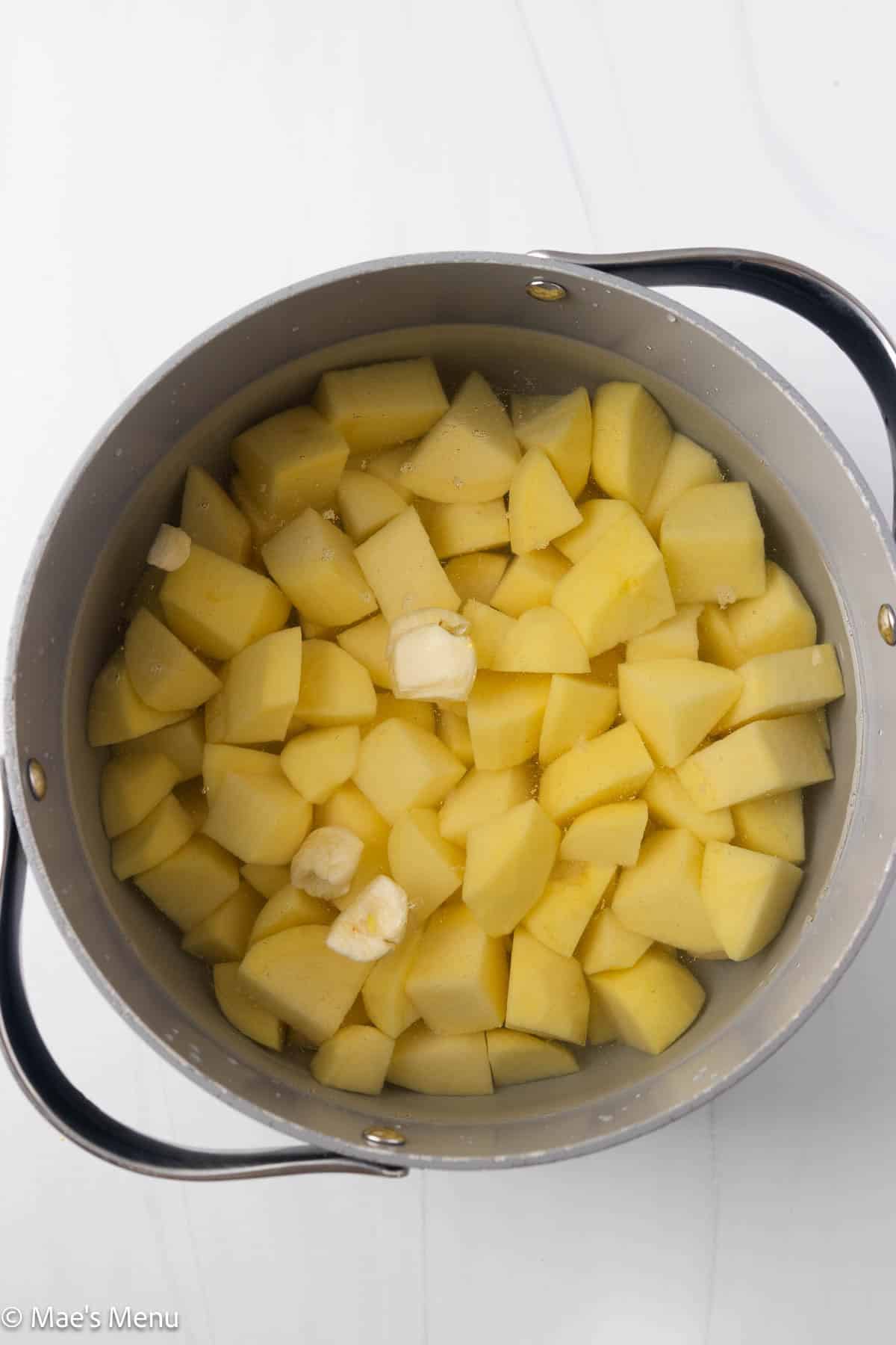 The pot of potatoes and garlic before boiling.