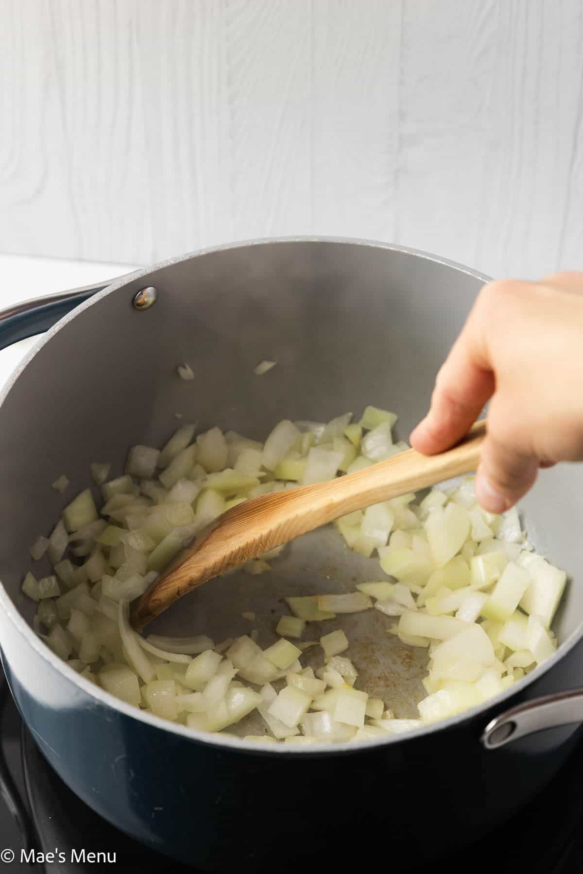 Sauteeing a large pot of onions.