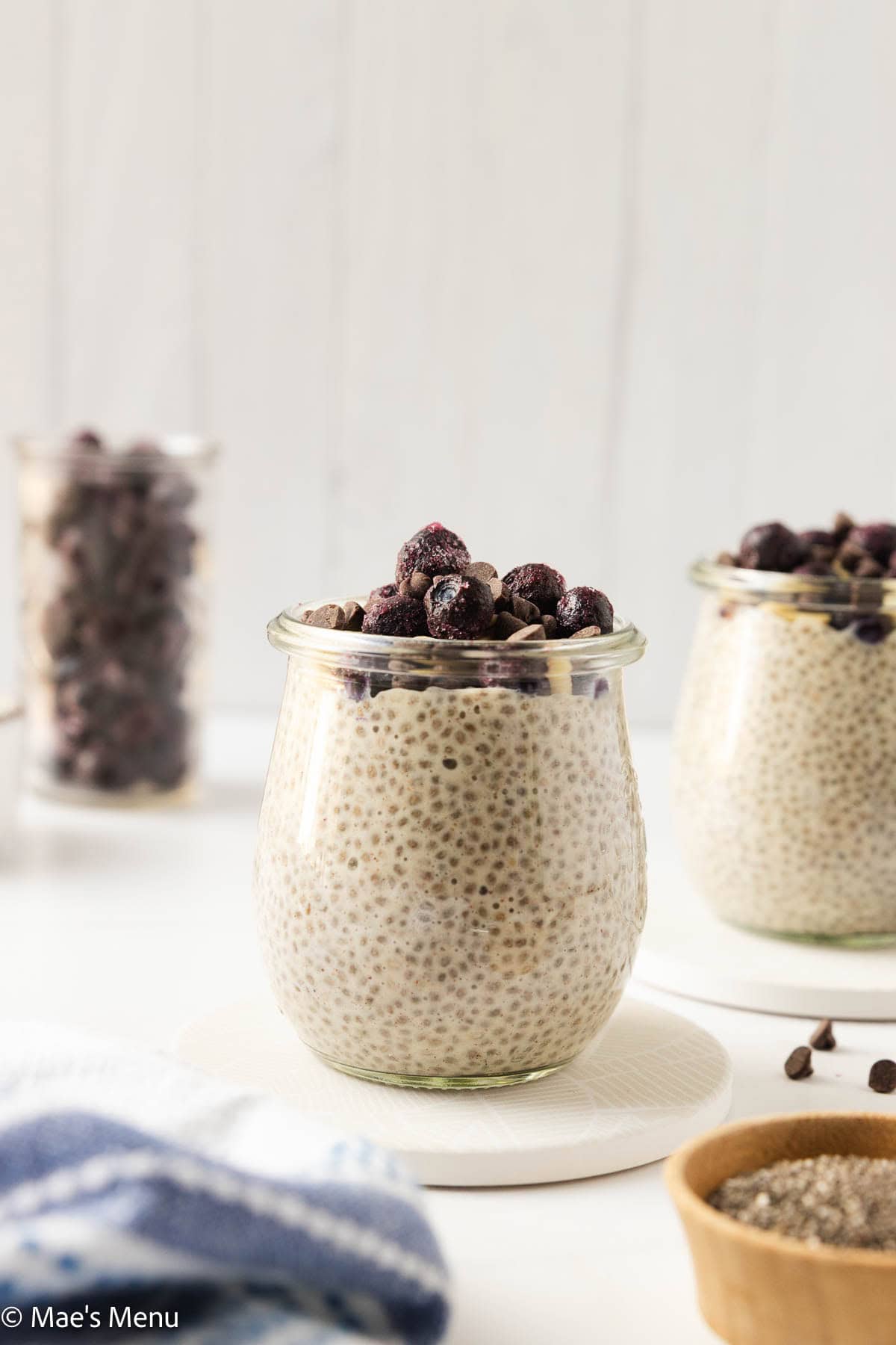 A side shot of a glass of high protein chia pudding on the counter. 