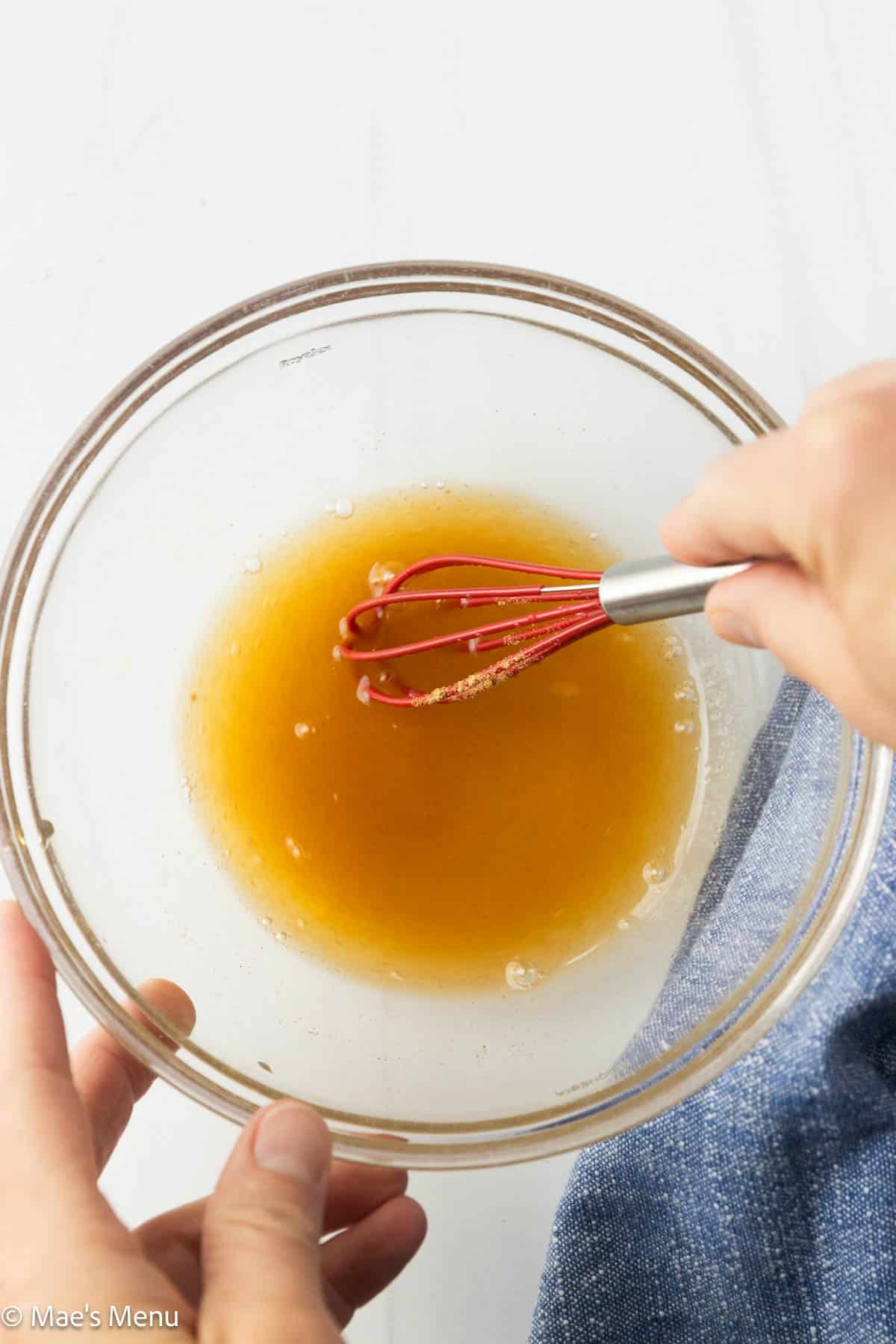 Whisking the citrus honey fruit salad dressing.