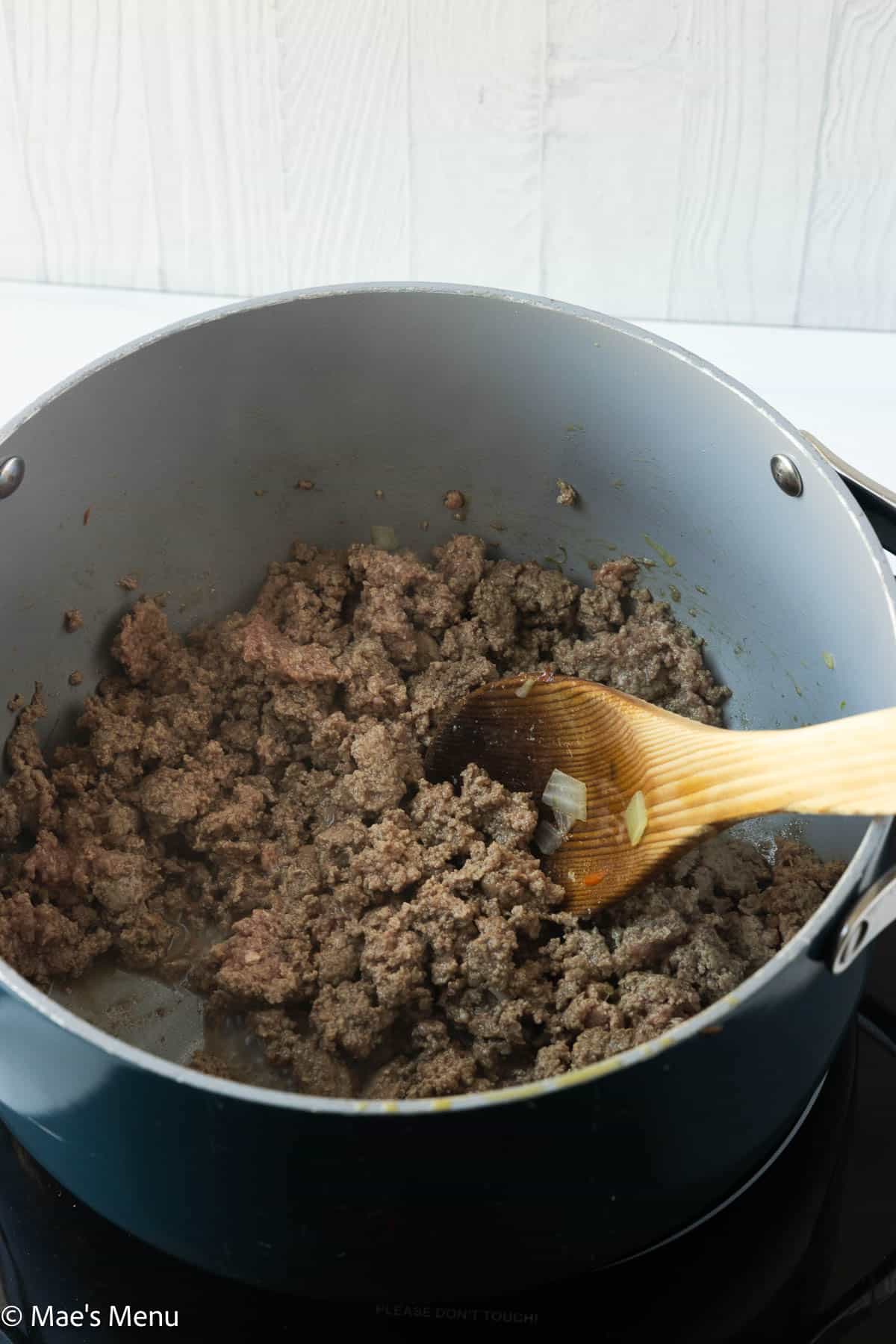Browning the bison in a large pot.