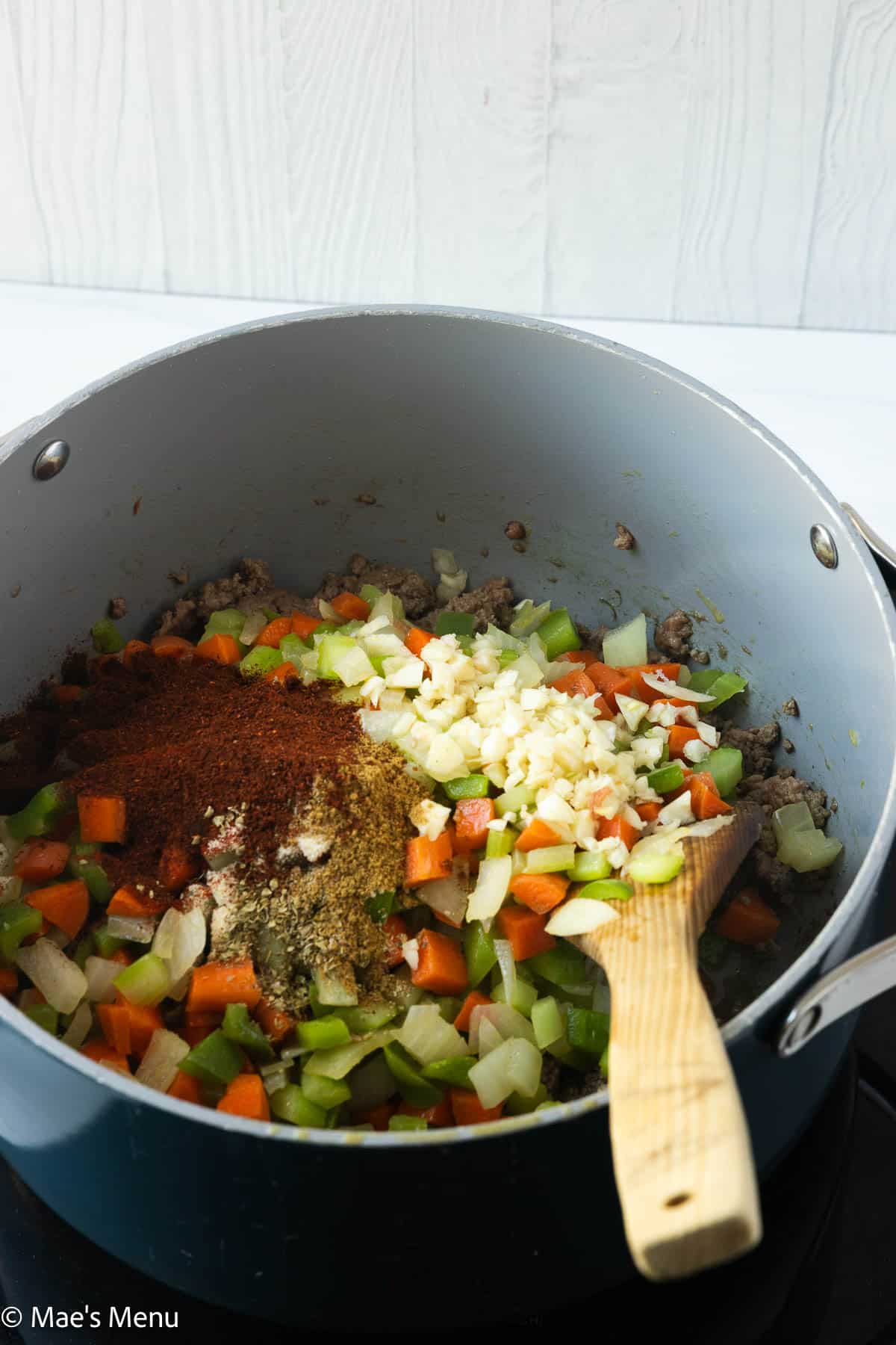 The sauteed veggies, seasonings, and garlic in a large pot.
