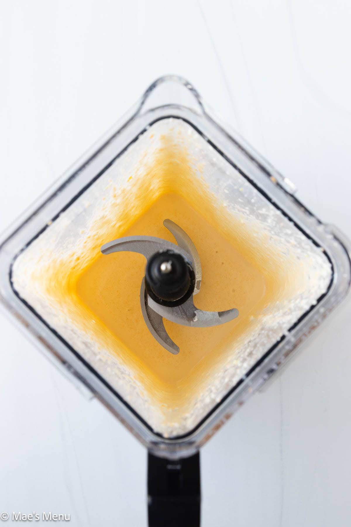 An overhead shot of a blender full of high protein mac and cheese sauce before simmering.