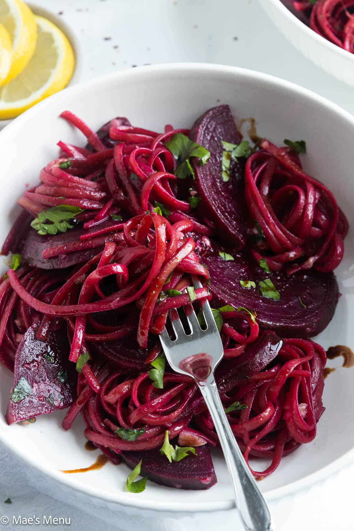 A close-up shot of red pasta twirled around a fork.