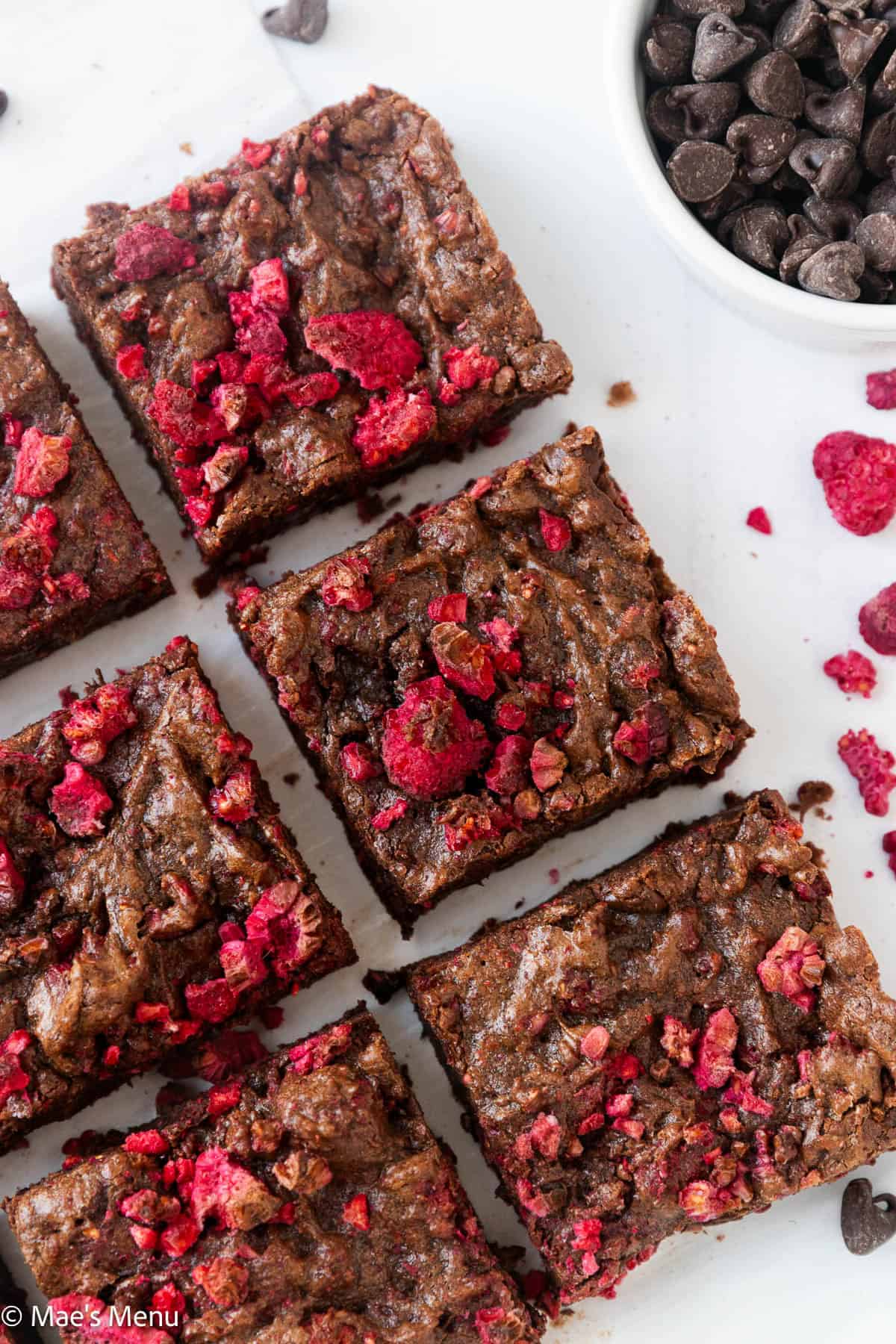 A close-up overhead shot of sliced raspberry brownies on the counter.