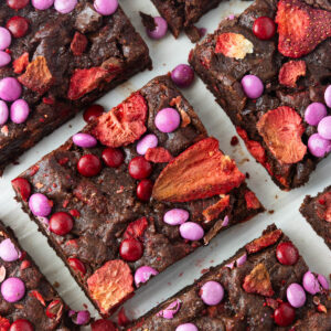 A close-up overhead shot of a pan of sliced strawberry brownies.
