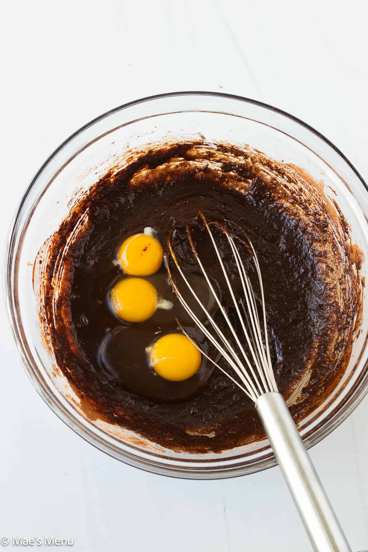 Eggs and vanilla extract added to the brownie base.