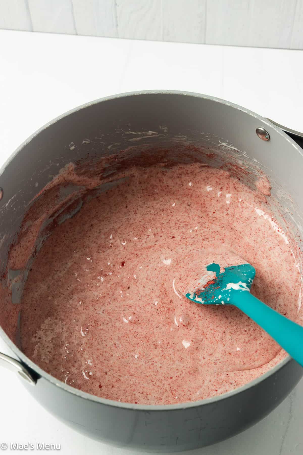 The strawberry and melted marshmallow mixture in a large pot.