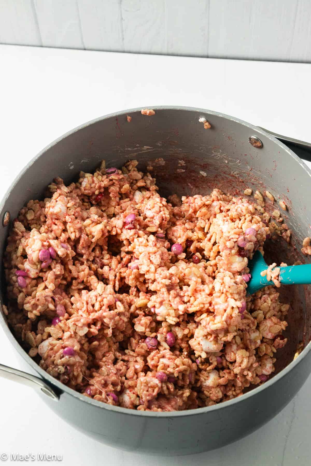 The strawberry rice krispie mixture in a large pot.