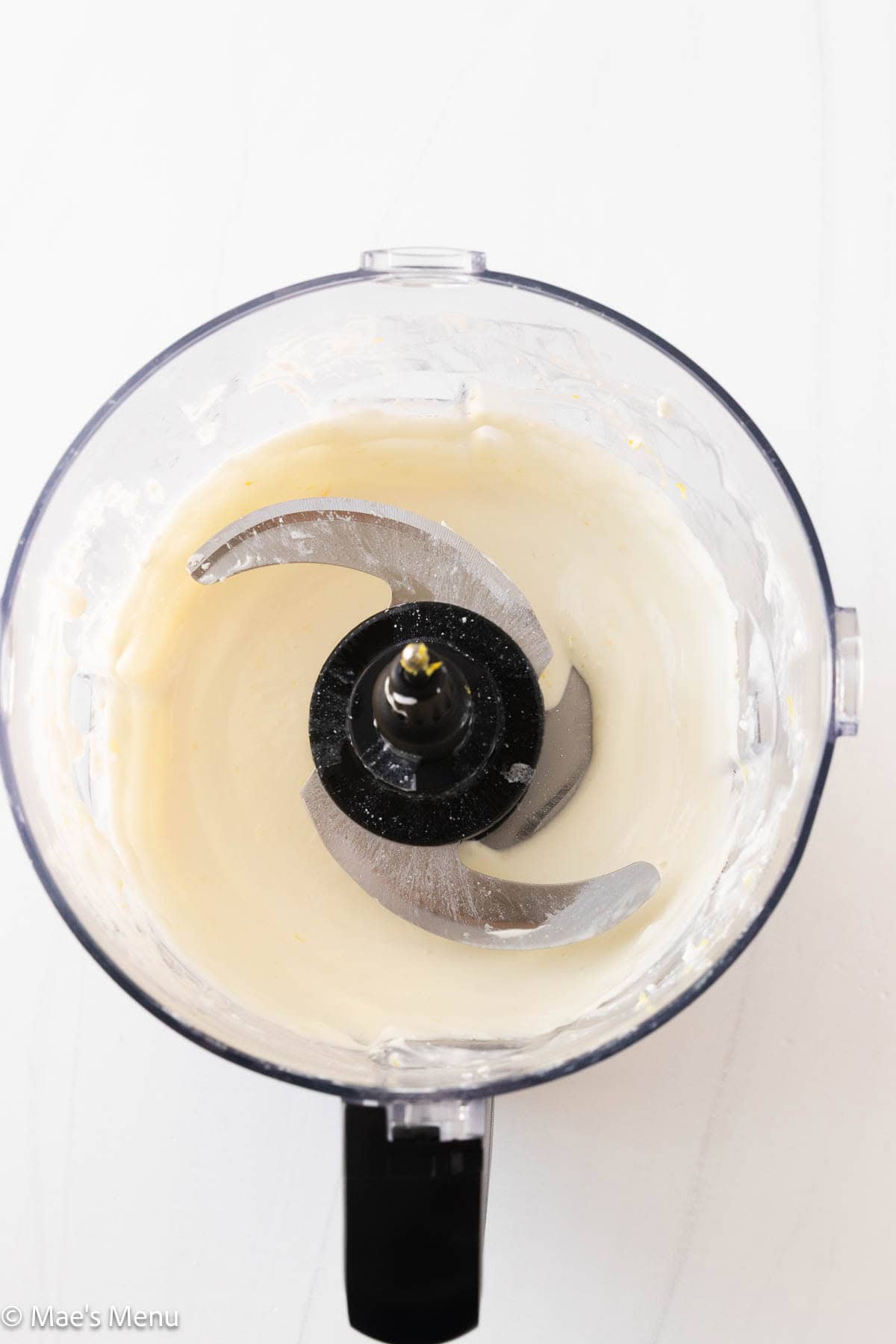 An overhead shot of the whipped cottage cheese dip in the food processor.