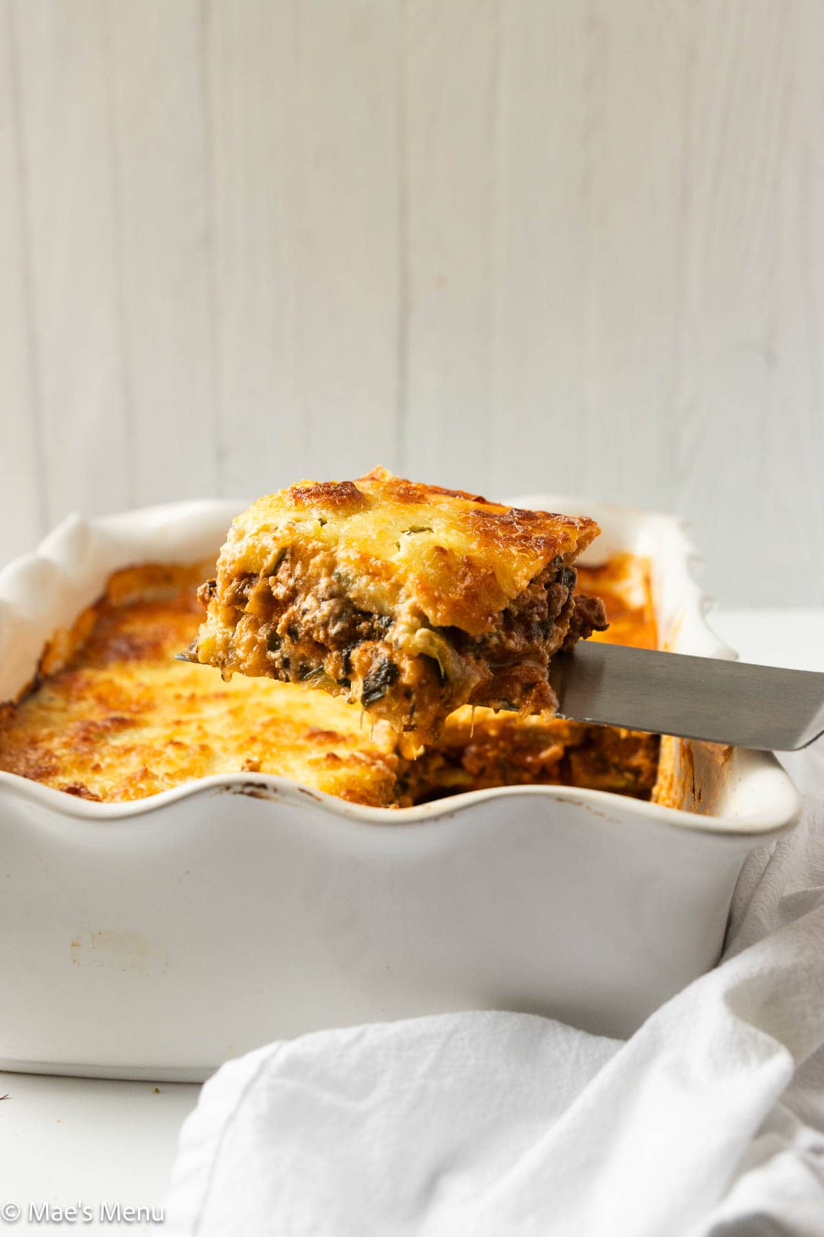 A side shot of taking a slice of zucchini lasagna.