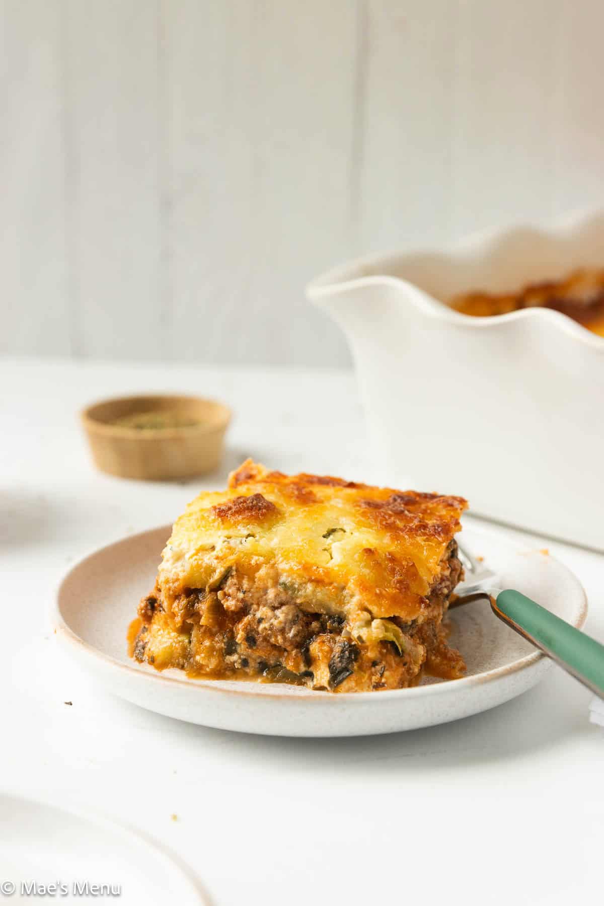 A side shot of a slice of zucchini lasagna on a plate.