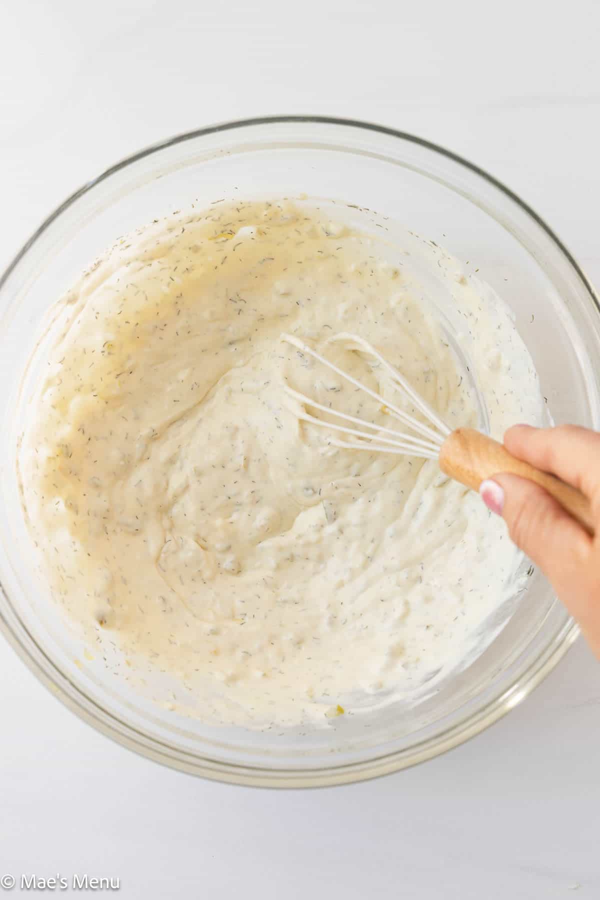 An overhead shot of a bowl of the tuna pasta salad dressing.