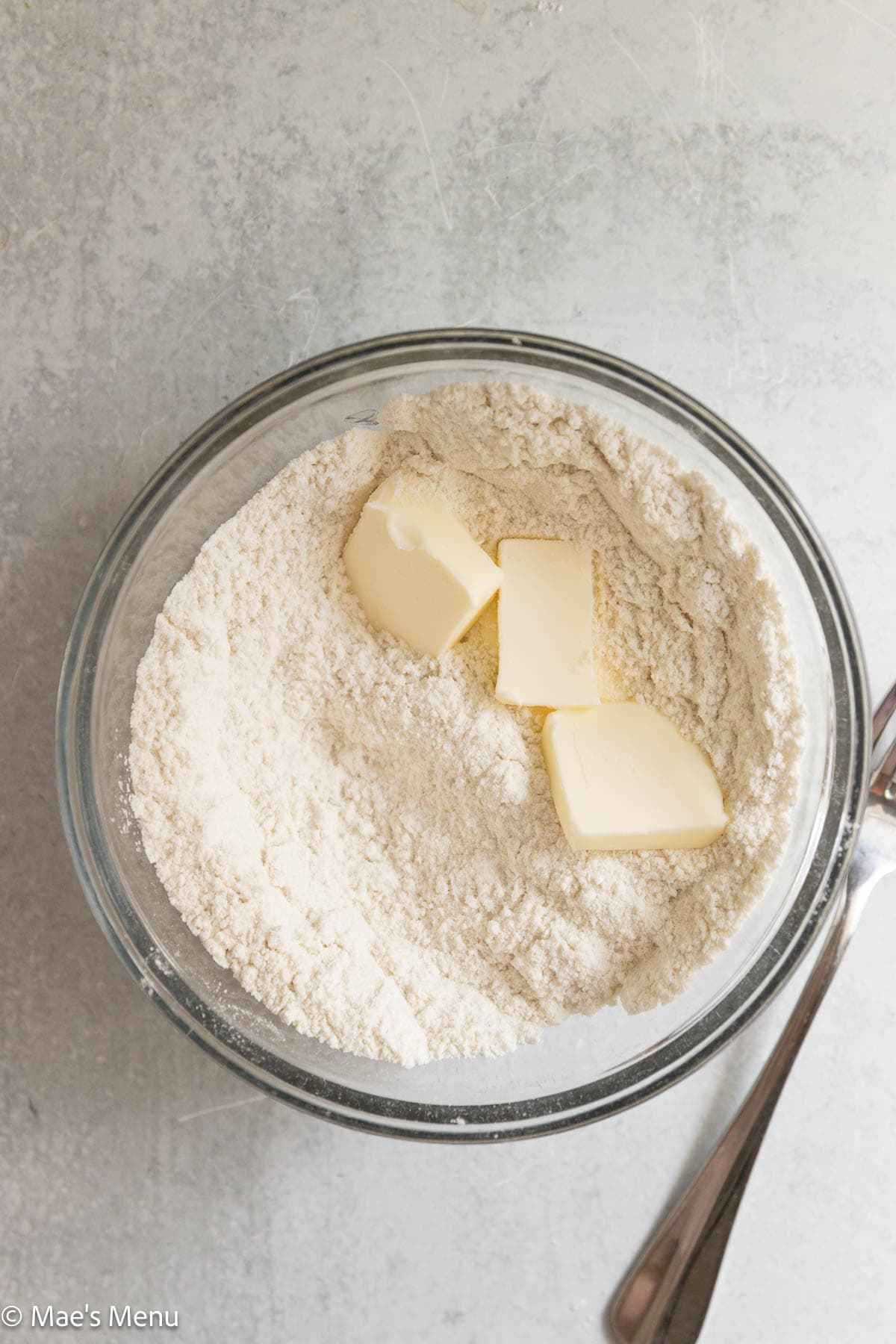 A mixing bowl with butter in it.